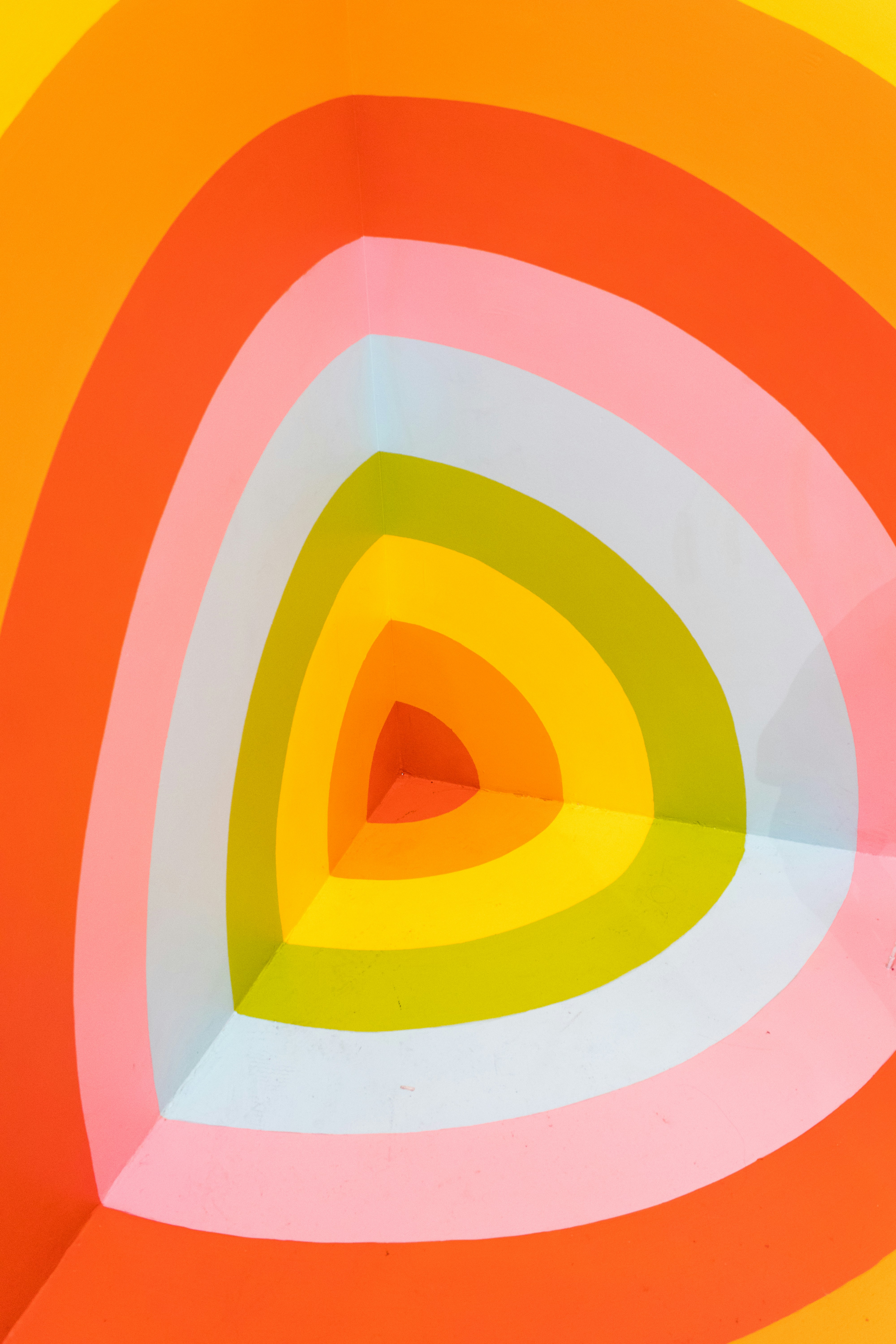 Layers of coloured rings in a wall corner, looking like a cut-out segment.